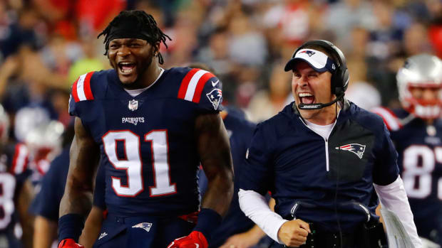 Patriots linebacker Jamie Collins and coordinator Josh McDaniels celebrate a play on the sideline.