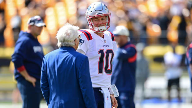 New England Patriots owner Robert Kraft talks with New England Patriots quarterback Mac Jones (10) before the game against the Pittsburgh Steelers at Acrisure Stadium.