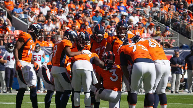 Denver Broncos quarterback Russell Wilson (3) huddles with his teammates in the second quarter against the Houston Texans at Empower Field at Mile High.