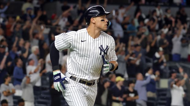 Aaron Judge #99 of the New York Yankees hits his 60th home run of the season during the 9th inning of the game against the Pittsburgh Pirates at Yankee Stadium on September 20, 2022 in the Bronx borough of New York City.