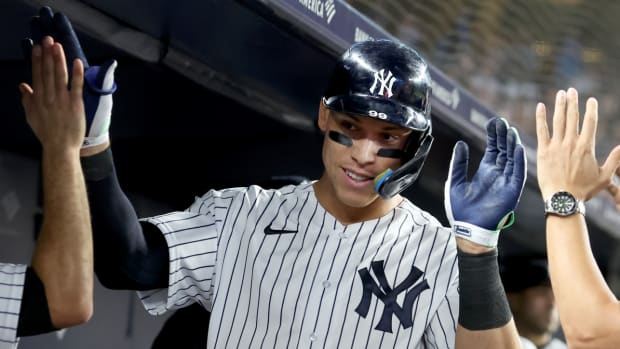 New York Yankees right fielder Aaron Judge (99) celebrates his 60th home run of the season with teammates in the dugout on Sept. 20, 2022.