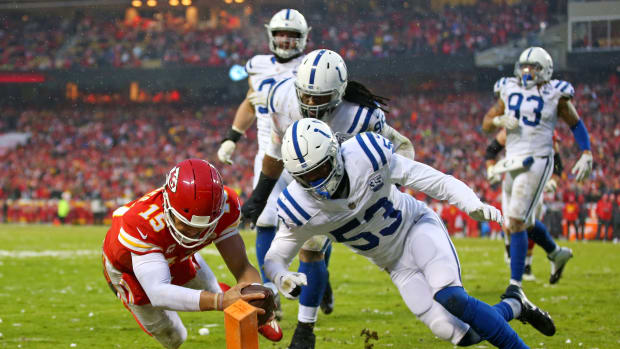 Jan 12, 2019; Kansas City, MO, USA; Kansas City Chiefs quarterback Patrick Mahomes (15) scores a touchdown against Indianapolis Colts outside linebacker Darius Leonard (53) during the second quarter in an AFC Divisional playoff football game at Arrowhead Stadium.