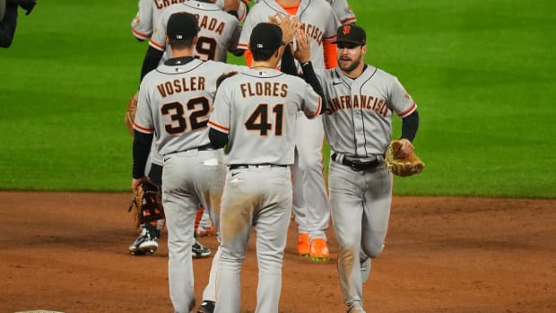 Sep 21, 2022; Denver, Colorado, USA; San Francisco Giants right fielder Luis Gonzalez (51) and third baseman Jason Vosler (32) and San Francisco Giants second baseman Wilmer Flores (41) celebrates defeating the Colorado Rockies at Coors Field. Mandatory Credit: Ron Chenoy-USA TODAY Sports