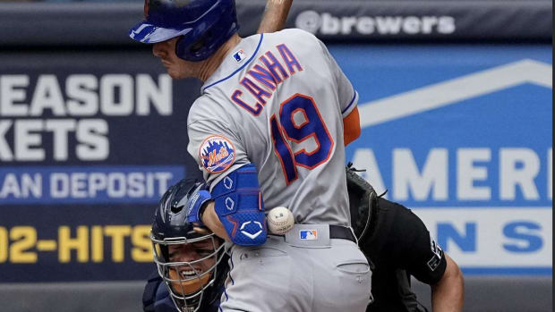 Sep 21, 2022; Milwaukee, Wisconsin, USA; New York Mets left fielder Mark Canha (19) is hit by a pitch thrown by Milwaukee Brewers starting pitcher Adrian Houser during the fifth inning at American Family Field.