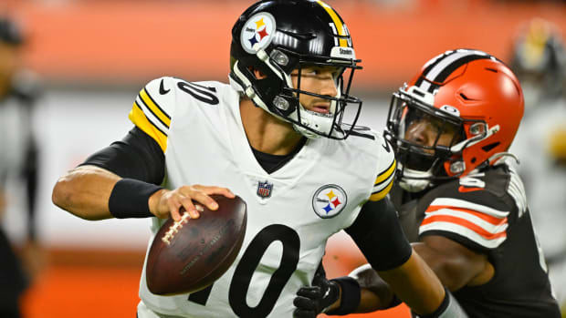 Pittsburgh Steelers quarterback Mitch Trubisky (10) rolls out with Cleveland Browns linebacker Anthony Walker Jr. (5) in pursuit during the first half of an NFL football game in Cleveland on Thursday, Sept. 22, 2022. (AP Photo/David Richard)