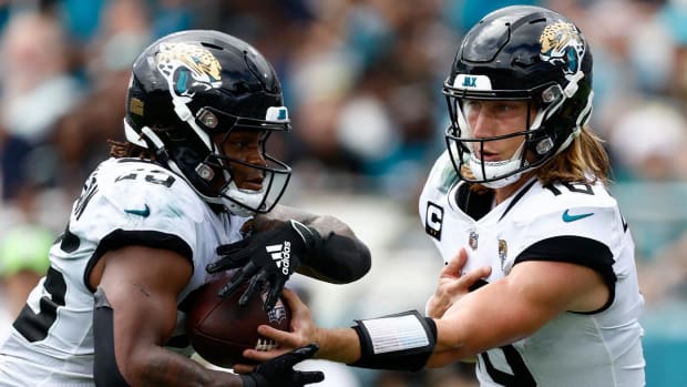 Sep 18, 2022; Jacksonville, Florida, USA; Jacksonville Jaguars quarterback Trevor Lawrence (16) hands the ball off to running back James Robinson (25) against the Indianapolis Colts during the third quarter at TIAA Bank Field.