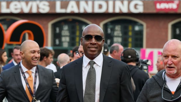 SF Giants consultant Barry Bonds looks into the camera in front of a group of people at Oracle Park during Will Clark's number retirement ceremony. (2022)