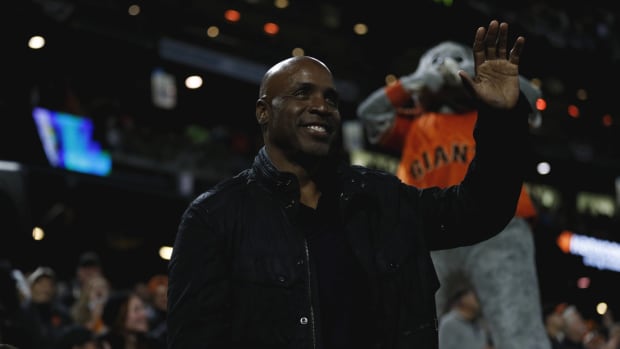 Former Giants outfielder Barry Bonds waves at fans while attending a Giants game in 2021.