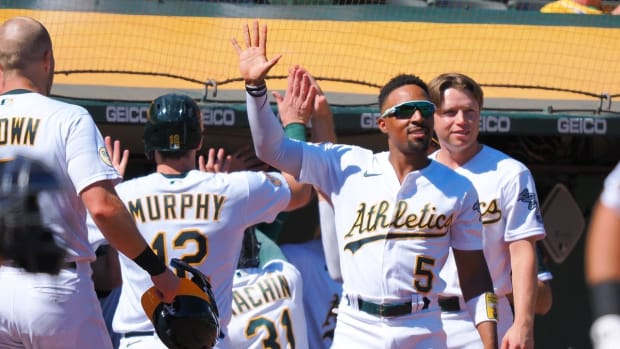 Sep 22, 2022; Oakland, California, USA; Oakland Athletics left fielder Tony Kemp (5) greets center fielder Seth Brown (15), catcher Sean Murphy (12) and third baseman Vimael Machin (31) after they both score runs against the Seattle Mariners during the third inning at RingCentral Coliseum. Mandatory Credit: Kelley L Cox-USA TODAY Sports
