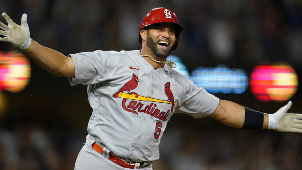 Cardinals designated hitter Albert Pujols (5) watches after hitting a home run during the fourth inning of a baseball game against the Los Angeles Dodgers in Los Angeles, Friday, Sept. 23, 2022. It was Pujols’ 700th career home run.