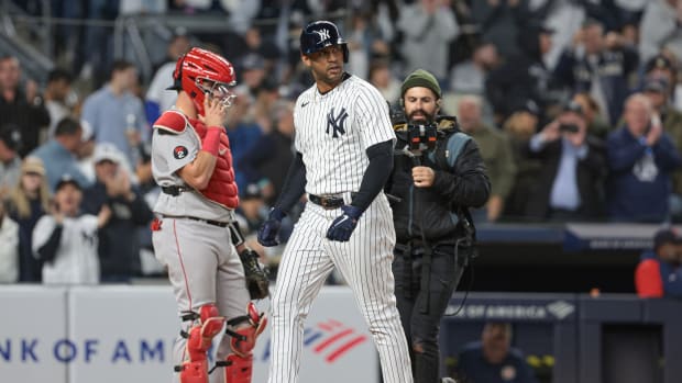 New York Yankees OF Aaron Hicks touches home plate on home run