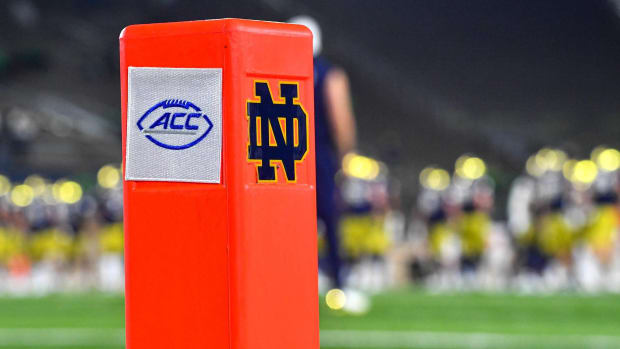 A football endzone pylon with the ACC and Notre Dame logos on it.