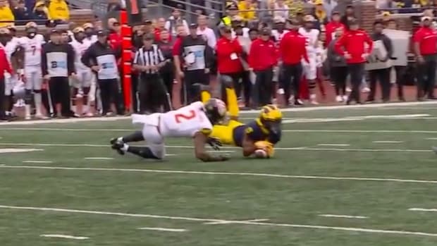 Screenshot of Michigan defensive back DJ Turner intercepting a pass throwing by Maryland quarterback Taulia Tagovailoa in the first half of a game between the Big Ten teams.