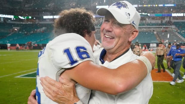 Middle Tennessee head coach Rick Stockstill, right, hugs quarterback Chase Cunningham (16) after they beat Miami 45-31 in an NCAA college football game, Saturday, Sept. 24, 2022, in Miami Gardens, Fla. (AP Photo/Wilfredo Lee)