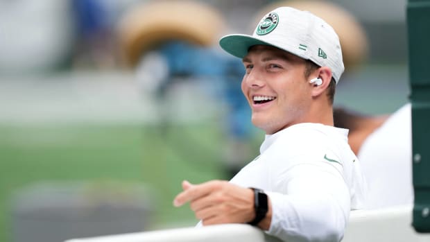 Jets quarterback Zach Wilson smiles while on the bench before a preseason game vs. the Giants.