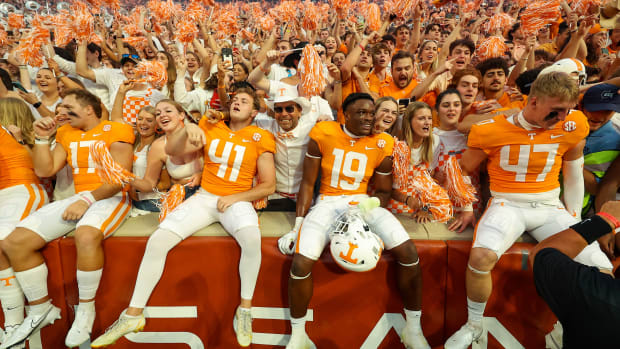 Tennessee Volunteers players celebrate with fans after the game against the Florida Gators at Neyland Stadium.