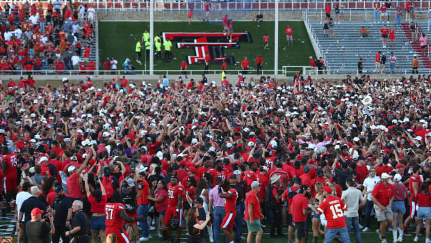 The Texas Tech Red Raiders student body celebrate on the field after defeating the Texas Longhorns in overtime at Jones AT&T Stadium and Cody Campbell Field.