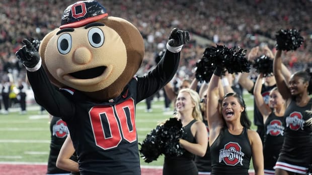 Ohio State's mascot Brutus celebrates a win over Wisconsin with cheerleaders.