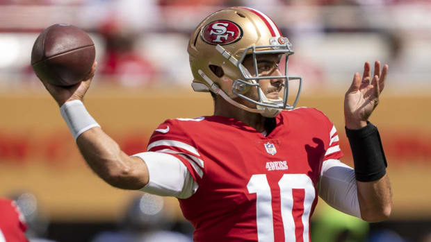 49ers quarterback Jimmy Garoppolo throws a pass while warming up before going into a game vs. Seattle.