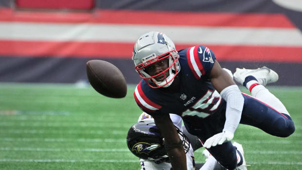 New England receiver Nelson Agholor , being brought down by Raven defender Kyle Hamilton, watches as his fumbled ball bounces away after a 28yard ,4th quarter run. The ball was recovered by the Ravens and ended Patriots chances of a comeback win. Patriots home opener against the Baltimore Ravens on Sept 25, 2022.