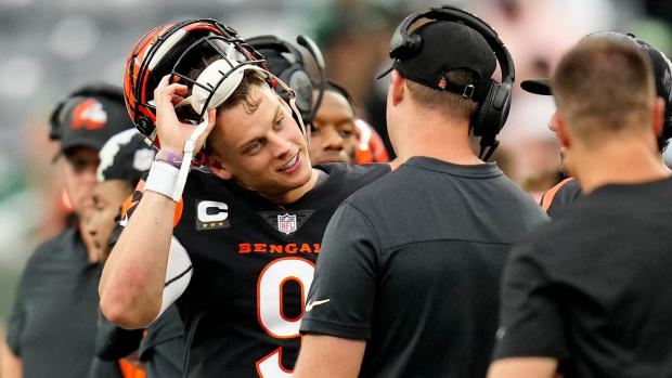 Cincinnati Bengals quarterback Joe Burrow (9) and head coach Zac Taylor talk as the offense comes off the field in the fourth quarter of the NFL Week 3 game between the New York Jets and the Cincinnati Bengals at MetLife Stadium in East Rutherford, N.J., on Sunday, Sept. 25, 2022. The Bengals improved to 1-2 on the season with a 27-12 win over the Jets. Cincinnati Bengals At New York Jets Week 3