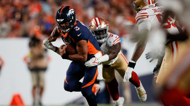 Denver Broncos quarterback Russell Wilson (3) is tackled by San Francisco 49ers defensive end Charles Omenihu (94) in the second quarter at Empower Field at Mile High.