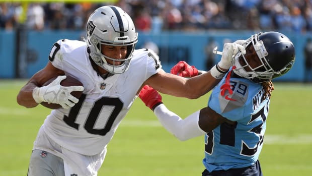 Las Vegas Raiders wide receiver Mack Hollins (10) pushes off on a tackle attempt by Tennessee Titans cornerback Terrance Mitchell (39) during the second half at Nissan Stadium.