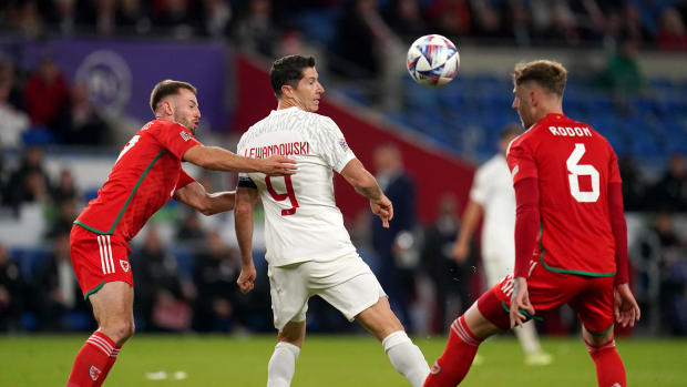 Robert Lewandowski (center) pictured flicking the ball past Joe Rodon (right) to assist a goal for Karol Swiderski (not in shot) during Poland's 1-0 win over Wales in September 2022