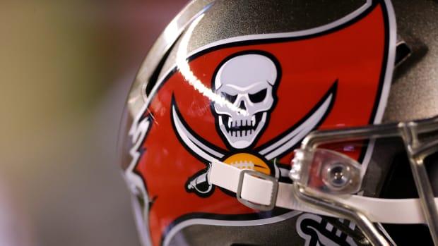 A view of the Tampa Bay Buccaneers logo on a helmet on the sidelines.