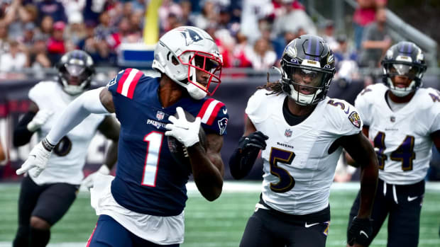 Patriots receiver DeVante Parker looks over his shoulder to Raven defenders in pursuit after a 40yd gain in the first quarter. Patriots home opener against the Baltimore Ravens on Sept 25, 2022.
