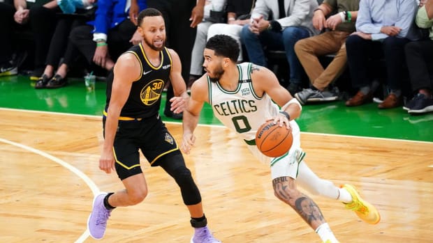 Jun 10, 2022; Boston, Massachusetts, USA; Boston Celtics forward Jayson Tatum (0) dribbles the ball against Golden State Warriors guard Stephen Curry (30) during the fourth quarter of game four in the 2022 NBA Finals at the TD Garden.