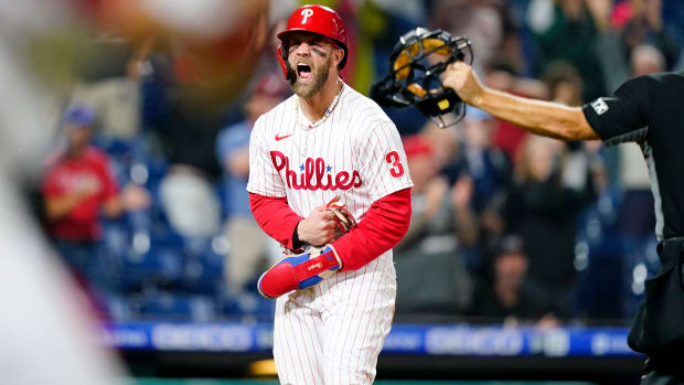 Philadelphia Phillies’ Bryce Harper celebrates after scoring the game-winning run on an RBI-single by Jean Segura during the ninth inning of a baseball game, Tuesday, Sept. 6, 2022, in Philadelphia.