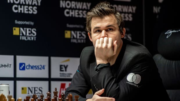 Chess world champion Magnus Carlsen looks on while preparing to start a match.