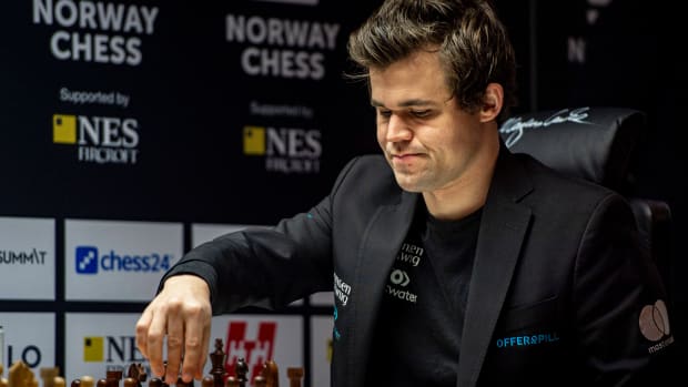 Magnus Carlsen makes a move during a chess match