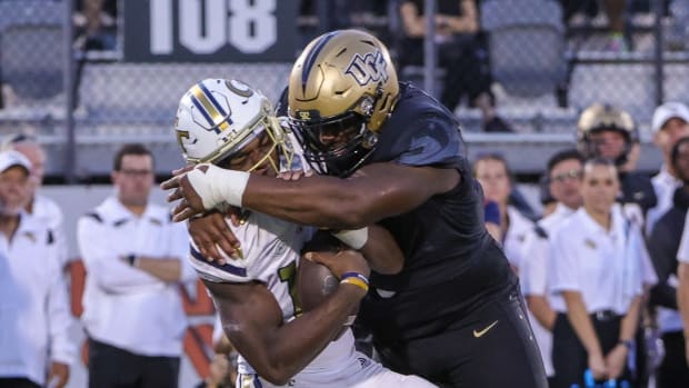 Sep 24, 2022; Orlando, Florida, USA; Georgia Tech Yellow Jackets quarterback Jeff Sims (10) is sacked by UCF Knights defensive tackle Ricky Barber (5) during the second half at FBC Mortgage Stadium. Mandatory Credit: Mike Watters-USA TODAY Sports