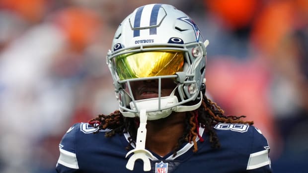 Cowboys wide receiver CeeDee Lamb looks on with his helmet on during a preseason game.
