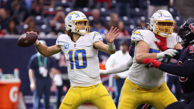Dec 26, 2021; Houston, Texas, USA; Los Angeles Chargers quarterback Justin Herbert (10) throws a pass that is intercepted by Houston Texans cornerback Tavierre Thomas (not pictured) during the fourth quarter at NRG Stadium. Mandatory Credit: Troy Taormina-USA TODAY Sports
