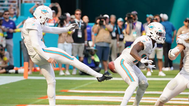 Dolphins punter Thomas Morstead (4) punts the ball into the backside of wide receiver Trent Sherfield (14) resulting in a safety for the Bills during the second half at Hard Rock Stadium.