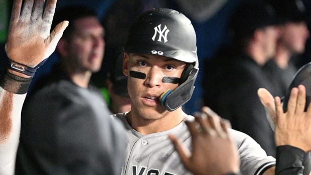 New York Yankees center fielder Aaron Judge (99) celebrates in the dugout with team mates after scoring against the Toronto Blue Jays in the fifth inning at Rogers Centre.