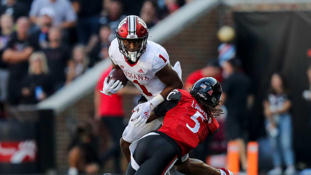 Sep 24, 2022; Cincinnati, Ohio, USA; Indiana Hoosiers wide receiver Donaven McCulley (1) runs with the ball against Cincinnati Bearcats safety Ja'Quan Sheppard (5) in the second half at Nippert Stadium. Mandatory Credit: Katie Stratman-USA TODAY Sports