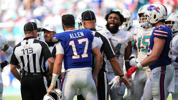 Referees work to separate Bills quarterback Josh Allen (17) and Dolphins defensive tackle Christian Wilkins (94) during the second half.