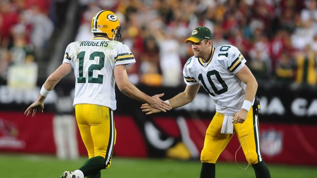 Packers quarterback Aaron Rodgers (12) celebrates with quarterback Matt Flynn (10) against the Cardinals.