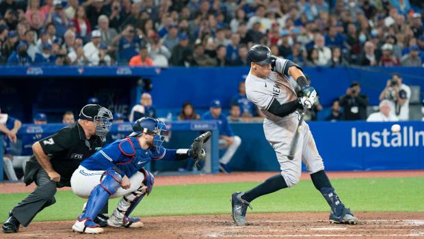 Yankees designated hitter Aaron Judge (99) hits his 61st home run scoring two runs against the Toronto Blue Jays.