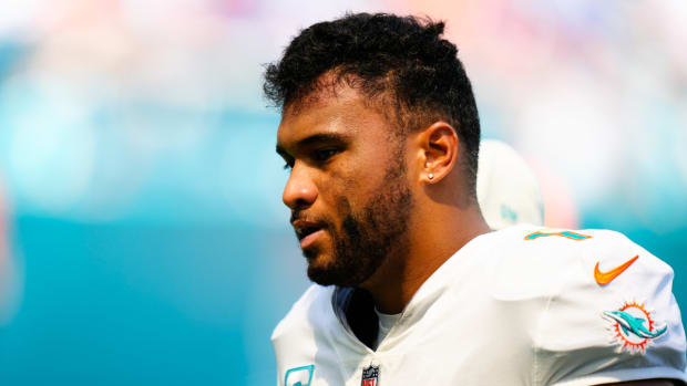 Miami Dolphins quarterback Tua Tagovailoa (1) is helped off the field by staff after a apparent injury against the Buffalo Bills on Sept. 25, 2022.