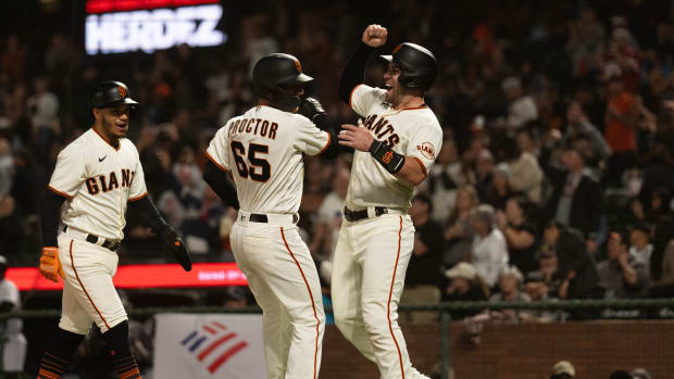 SF Giants second baseman Ford Proctor (65) celebrates with catcher Austin Wynns (14) after hitting a grand slam during the second inning against the Rockies. (2022)