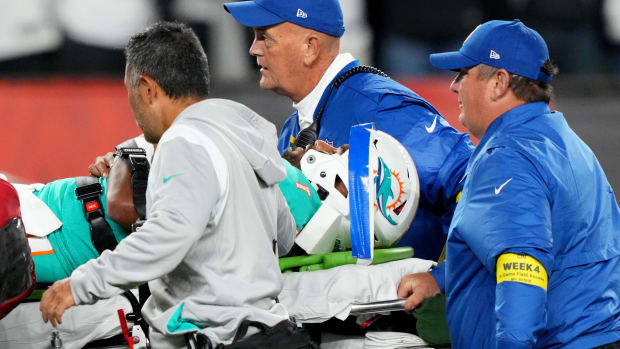 Dolphins quarterback Tua Tagovailoa (1) is taken off the field after suffering a head injury following a sack by Cincinnati Bengals defensive tackle Josh Tupou.