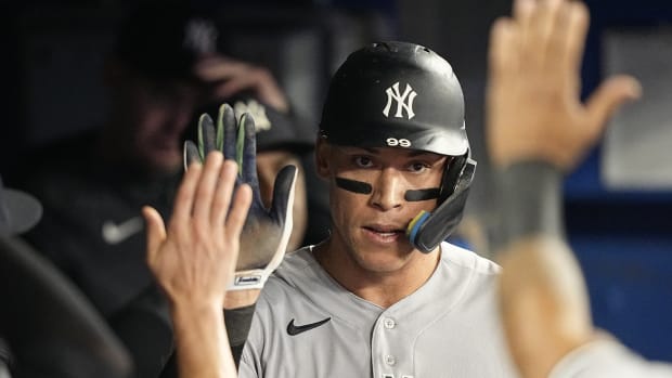 New York Yankees OF Aaron Judge high fives in dugout against Toronto Blue Jays