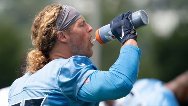 Tennessee Titans outside linebacker Derrek Tuszka (55) takes a drink as he warms up during practice at Ascension Saint Thomas Sports Park Monday, Sept. 5, 2022, in Nashville, Tenn.