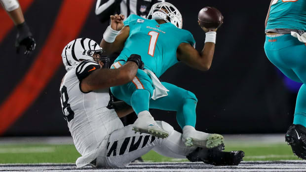 Bengals defensive tackle Josh Tupou (68) sacks Miami Dolphins quarterback Tua Tagovailoa (1) in the first half at Paycor Stadium. Tagovailoa sustained a head injury on the play and left the game for treatment.