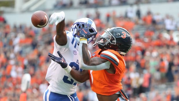 Virginia Cavaliers wide receiver Dontayvion Wicks attempts to catch a pass against the Duke Blue Devils.